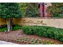 A beautifully landscaped sign for One River Place with mature trees and flowerbeds at 200 River Vista Dr # 120, Atlanta, GA 30339
