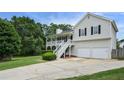 Well-maintained two-story home featuring a charming front porch and an attached two-car garage at 259 Pine Valley Dr, Powder Springs, GA 30127