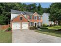 Inviting two-story home with red brick and black shutters, complemented by a green lawn at 4321 Sugar Maple Chase Nw, Acworth, GA 30101