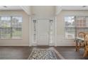 Bright foyer with a white door, sidelights, hardwood floors, and natural light at 4321 Sugar Maple Chase Nw, Acworth, GA 30101