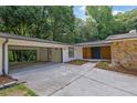 Beautiful home featuring a double door entrance, stone accents, fresh landscaping, and an attached carport at 4717 Westhampton Dr, Tucker, GA 30084