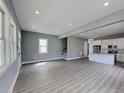 Open-concept living space with hardwood floors, seamlessly connecting the living room and kitchen at 629 Windsor Sw St, Atlanta, GA 30312