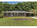Charming brick home featuring a well-manicured lawn, front carport, and inviting entryway, perfect for suburban living at 174 Zelma Sw St, Marietta, GA 30060