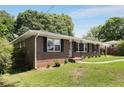 Attractive brick home with dark shutters and a lush, green lawn, offering a classic and welcoming curb appeal at 174 Zelma Sw St, Marietta, GA 30060
