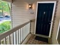 A covered porch leads to a classic navy blue front door with traditional hardware at 386 Teal Ct, Roswell, GA 30076