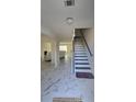 Inviting foyer with staircase and neutral tones offer a warm welcome at 771 Franklin Mill Trce, Loganville, GA 30052