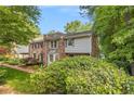 Two-story townhome with brick and vinyl siding, a bay window, and landscaped front at 1505 September Chase, Decatur, GA 30033