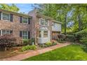 Charming townhome featuring brick and siding, a bay window, and mature landscaping at 1505 September Chase, Decatur, GA 30033
