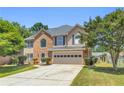 Charming two-story home with an attached two-car garage and well-manicured lawn at 3327 James Harbor Way, Lawrenceville, GA 30044