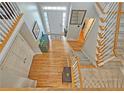 Bright, open foyer with hardwood floors, a staircase, and a clear view of the front door at 3740 Ashford Ne Pt, Brookhaven, GA 30319