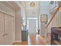 Bright, two-story foyer features hardwood floors, a staircase, and closet for a welcoming first impression at 3740 Ashford Ne Pt, Brookhaven, GA 30319
