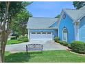 Garage exterior with a blue-painted finish and meticulously maintained landscaping at 3740 Ashford Ne Pt, Brookhaven, GA 30319