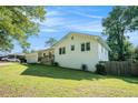 White brick home showing yard, landscaping, and covered porch, with visible windows offering ample natural light at 4384 Herschel Rd, College Park, GA 30337