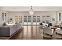 Spacious living room featuring ample seating, hardwood floors, and abundant natural light at 591 E Morningside Ne Dr, Atlanta, GA 30324