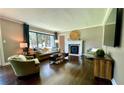 Inviting living room with hardwood floors, fireplace, large windows, and comfortable furnishings at 727 Channing Nw Dr, Atlanta, GA 30318