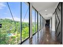 Spacious hallway boasts floor-to-ceiling windows with views and dark wood flooring at 130 26Th Nw St # 801, Atlanta, GA 30309