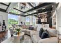 This living room features floor to ceiling windows, wood floors, black beam ceilings and comfortable furniture at 130 26Th Nw St # 801, Atlanta, GA 30309