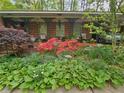 Cozy front porch featuring decorative iron supports and lush flowerbeds at 2564 Wren Nw Ave, Duluth, GA 30096