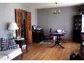 Inviting living room with hardwood floors, a chandelier, and bi-fold doors at 2564 Wren Nw Ave, Duluth, GA 30096