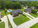 Aerial view of beautiful property featuring well-maintained yard, pool, and brick home at 811 Ivy Ridge Dr, Loganville, GA 30052