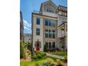Beautiful multi-story townhome featuring a brick facade and a vibrant red front door at 323 Concord St, Alpharetta, GA 30009