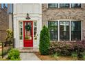Inviting red front door with wreath and a decorative welcome mat at 323 Concord St, Alpharetta, GA 30009