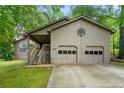 Spacious two-car garage with convenient access and charming exterior details at 5245 Olde Mill Rd, Woodstock, GA 30188