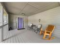 Covered front porch featuring ample seating and a stylish purple door at 5245 Olde Mill Rd, Woodstock, GA 30188