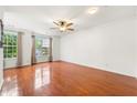Living room with gleaming hardwood floors, large windows and neutral paint to showcase light and space at 6213 Indian Wood Cir, Mableton, GA 30126