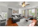 Bright living room with hardwood floors, large windows, and comfortable seating at 6213 Indian Wood Cir, Mableton, GA 30126
