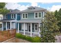 Inviting curb appeal with light-green and blue siding, white trim, and a charming front porch at 630 John Wesley Dobbs Ne Ave, Atlanta, GA 30312