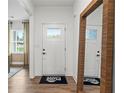 The entryway features a front door with glass and a welcome mat at 707 Mirror Lake Parkway Way, Villa Rica, GA 30180