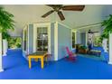 Spacious front porch featuring a blue floor, ceiling fans, and comfortable seating area at 7550 Fielder Rd, Jonesboro, GA 30236