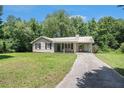 Charming one-story home with a metal roof, teal door, and well-maintained front yard at 10312 Waterford Ne Rd, Covington, GA 30014