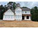 Exterior view of home under construction with house wrap and wooded backdrop at 3435 Dr Bramblett Rd, Cumming, GA 30028