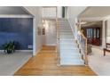 Bright and airy entryway featuring hardwood floors, a staircase, and elegant trim details at 3580 Treeline Ne Pass, Roswell, GA 30075