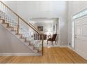 Inviting entryway with hardwood floors, staircase, and a view into the living room at 3580 Treeline Ne Pass, Roswell, GA 30075