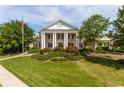 Elegant clubhouse with stately columns, manicured landscaping, and a welcoming entrance at 221 Village Overlook # H2, Canton, GA 30114