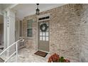 Cozy entryway with brick wall, decorative wreath, and a 'Welcome' mat at 2499 Barrett Preserve Sw Ct, Marietta, GA 30064