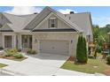 Attractive townhome showing a well-manicured lawn and an attached two-car garage at 2499 Barrett Preserve Sw Ct, Marietta, GA 30064