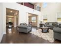 Bright living room with hardwood floors, high ceilings, and comfortable seating arrangement at 320 Conley Ave, Hampton, GA 30228