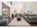 Inviting living room with tall ceilings, large windows, and hardwood floors at 320 Conley Ave, Hampton, GA 30228