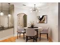 Stylish dining area with modern chandelier, round table, and hardwood floors at 3621 Vinings Slope Se # 1231, Atlanta, GA 30339