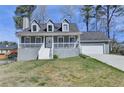 Charming two-story home with a front porch and attached two-car garage at 1001 Pine Ridge Dr, Stone Mountain, GA 30087