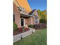 Lovely home exterior featuring a brick facade, manicured flower beds, and walkway lighting at 3 Tiffany Trce, Palmetto, GA 30268