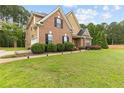 Beautiful home with lush green lawn, landscaping, and a side-entry garage at 3 Tiffany Trce, Palmetto, GA 30268