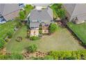 Aerial view of a home and large back yard with lush green lawn and mature landscaping at 3179 Falls Crest Ct, Buford, GA 30519