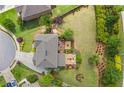 Aerial view of the landscaped backyard, complete with deck and fire pit seating area at 3179 Falls Crest Ct, Buford, GA 30519