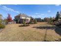 Expansive backyard featuring lush green lawn and landscaping, providing ample space for outdoor activities at 3179 Falls Crest Ct, Buford, GA 30519