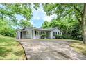 Beautiful single-story home with a well-kept lawn and a long driveway leading up to it at 3242 College St, Atlanta, GA 30337